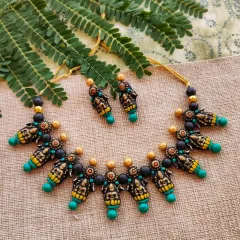 This is another color variation of my Mahalakshmi temple necklace, featuring sea-green accents instead of dark green. The antique gold finish remains, giving it a classic, heirloom quality.