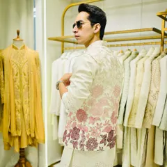 A look at our off-white bandhgala jacket with a beautiful pink and red floral embroidered pattern on the back. This is a modern twist on a classic silhouette.
