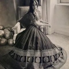 A black and white portrait that captures the bride's timeless beauty. The intricate details of her Sabyasachi lehenga and traditional jewelry stand out even in monochrome.
