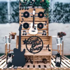 For the bride who wants to rock, this "Bach Shit Crazy" theme is a guaranteed hit. The setup features a rustic wooden backdrop, guitars, and vinyl records for an authentic rock and roll party vibe.
