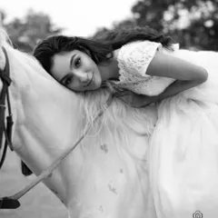 A black and white version of an intimate moment between the model and the horse. This edit brings a timeless and emotional quality to the portrait, focusing on connection and texture.