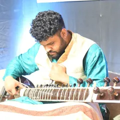 Tuning my sitar just before a performance. This moment of focus is essential to ensure the instrument is perfectly in tune, a discipline I carry into every studio recording.