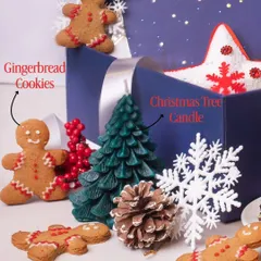 A close-up of the festive elements in our Christmas hampers. This image highlights our adorable, hand-decorated gingerbread cookies and a Christmas tree candle, which adds a non-edible festive touch to the gift box.