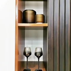 A detail of a display niche in Villa 9/21B, featuring fluted wood paneling and carefully selected decorative objects. We believe that even the smallest corners should be thoughtfully designed to contribute to the overall ambiance.