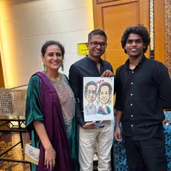 A happy couple posing with me and their finished caricature. It's always a pleasure to share in the joy of their celebration through my art.