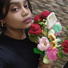 Here I am holding a large, mixed bouquet I created. It features red roses, calla lilies, and other colorful flowers, showing the variety of custom arrangements I can make.