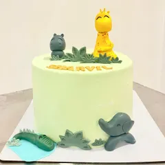 A cute and simple jungle theme cake. This design uses minimal fondant for the animal figurines like the giraffe, hippo, and elephant, keeping the focus on the delicious light green buttercream.