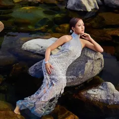A serene and powerful image of a Femina Miss India queen. We created a sleek, wet-look hairstyle to complement the high-fashion gown and the natural water element of the shoot.