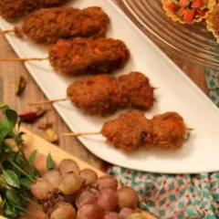 A close-up of my crispy chicken lollipops on skewers, ready for plating. This is a popular pass-around appetizer at parties.