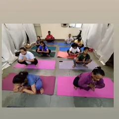 A group of students practicing Malasana, or the Garland Pose. This deep squat is excellent for opening the hips and grounding our energy, and we often hold it to find stillness.