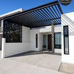 We designed this spacious carport to integrate with a modern villa's clean lines. The expansive louvered roof provides ample coverage for multiple vehicles, and the inclusion of a decorative privacy screen adds a touch of elegance while maintaining an open, airy feel.