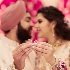 A beautiful close-up of the couple holding their engagement rings, with their faces softly blurred in the background. A symbol of their commitment.