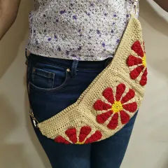 This is a full front view of the handmade Groovy Daisy fanny pack. You can clearly see the three bold, floral granny squares that give this crochet bag its signature look.