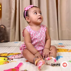 This adorable baby looks so comfortable in our pink printed romper. I design these to be functional and cute, making everyday moments with your little one extra special.