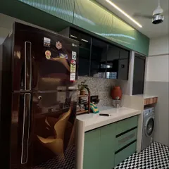A practical corner of the kitchen, showing how appliances like the refrigerator and washing machine are neatly integrated into the design.