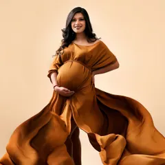 A moment of pure power and confidence. The rich, earthy brown of this flowing gown creates a dramatic effect, making the mom-to-be look like a goddess.
