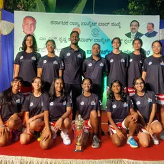 The MCHS U16 Girls team posing on stage with their trophy at the State U16 Youth Basketball Championship.