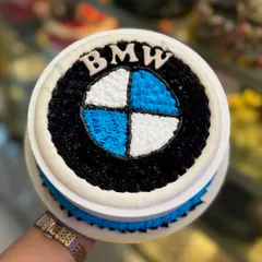 A classic BMW logo cake, meticulously crafted with buttercream piping. The iconic blue, white, and black colors are sharp and clean, making it a great choice for a BMW enthusiast's birthday.