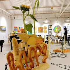The word 'Happy' is crafted from bread, forming part of the unique and interactive centerpiece.