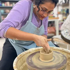 With gentle pressure and steady hands, a student begins to pull up the walls of a small cylinder. It's amazing to watch the form grow taller with each rotation.