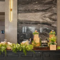 A rustic, nature-inspired food station with wooden blocks and fresh ferns. This setup is perfect for an organic or garden-themed event, showcasing how our culinary presentation can adapt to any style.