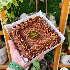I am obsessed with brownie cakes. This square walnut brownie cake is decorated with rich chocolate piping and golden sprinkles, ready for a birthday celebration.