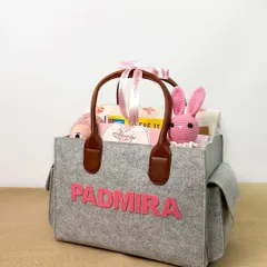 A personalized felt diaper bag hamper for a baby girl named 'Padmira'. This shot highlights the customization options available, which is a key selling point.