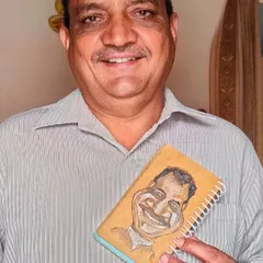 My papa holding the custom caricature I drew of him on a notepad. It’s a special feeling to create something for your own family.