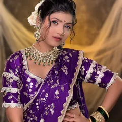 A full view of the regal purple Paithani look. I ensure the makeup, hairstyle with fresh flowers, and saree draping all come together to create a cohesive and stunning bridal portrait.
