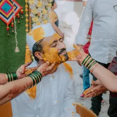 A close-up of the groom during his Haldi ceremony, as family members apply the turmeric paste. I capture the traditional aspects and the personal connections during these rituals.