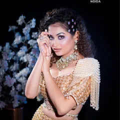 A full-length shot of the model, showcasing how the glam makeup, hair, and nails come together for a complete look. We teach our students to think about the entire aesthetic, not just one element.