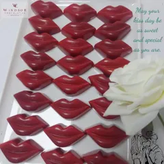 A tray of vibrant red, lip-shaped chocolates. These fun and romantic bonbons are perfect for Kiss Day or as a playful Valentine's gift.