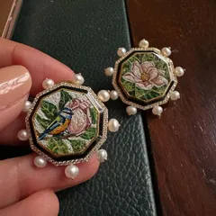 This pair of octagonal earrings features two different micromosaic scenes: a bird on a pink flower and a blooming magnolia. Framed with black enamel, diamonds, and pearls, they tell a story of nature's duality.