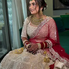 The full view of the bride, showcasing how the elegant updo adds a touch of sophistication to her overall bridal look.