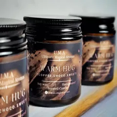 A trio of my 'Warm Hug' candles, which carry the essence of freshly ground coffee beans with a hint of choco. It's like a comforting wake-up call in a jar.