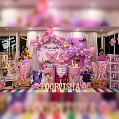 A dreamy butterfly-themed first birthday party that's as magical as it is beautiful. This setup features a stunning purple and pink balloon arch, custom name and age displays, and whimsical butterfly cutouts to create an enchanted garden atmosphere.
