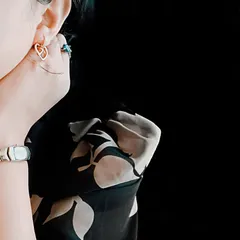 A detailed shot focusing on a delicate rose gold plated earring, part of a lifestyle product shoot. I use creative cropping and composition to draw attention to the product's features.