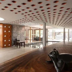 A custom-cut wooden bar top and a playful seal sculpture add an artistic, handcrafted touch to the resort's lounge, reflecting the unique culture of the region.