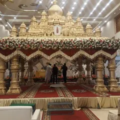 This is a great example of a grand, temple-style wedding mandap I designed. The intricate golden structure, combined with traditional red and white floral garlands, creates a divine and opulent atmosphere for the main ceremony.
