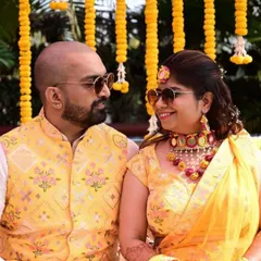 Twinning for the win. I love creating custom-coordinated outfits for couples, like this vibrant yellow lehenga and matching waistcoat for a Haldi ceremony. We can play with colors and designs to create the perfect look for you both.