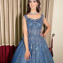 Dr. Srishti is absolutely killing it in this blue gown for her cocktail party. The makeup features a silver and blue cut-crease eye look.