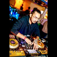 A close-up shot showing my hands on the decks. I've been spinning tracks for over two decades, and my passion for the craft is stronger than ever.