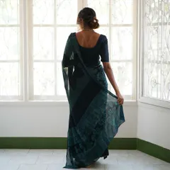 This is our hero item. The Nilā saree embodies our craft. It is a deep indigo silk georgette piece that took over 60 hours to create, combining intricate textures and custom-carved floral motifs using a specialized discharge printing technique.