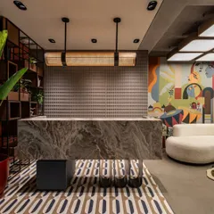 The mural as a backdrop for the office's reception area, creating a powerful first impression for clients. The artwork holds the pulse of a thousand stories of cities that never sleep.