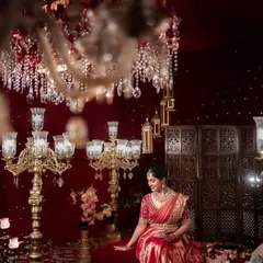 I love crafting portraits that feel both grand and personal. Here, the bride sits like royalty, surrounded by the warm glow of chandeliers, a timeless image of elegance and anticipation before her new beginning.