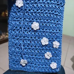 The blue book cover with its scattered white flowers, ready to wrap around a favorite novel. It’s both practical and pretty.
