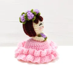 A side view of the reversible flower doll keychain.