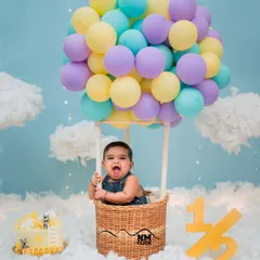 Up, up, and away! This half-birthday hot air balloon concept is one of our most popular creative themes. The pure excitement on this little one's face says it all.