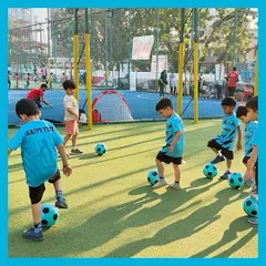 A typical day at our kids football camp involves lots of movement. Here, our students practice keeping the ball close as they move across the field, learning coordination and focus in a playful group setting.