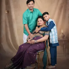 A beautiful family portrait celebrating the upcoming arrival. The family is dressed in traditional attire, creating a warm and cohesive image that honors their heritage.